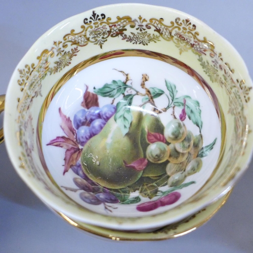 669 - An Ashley bone china set of six cups, saucers and tea plates, decorated with fruit and with 22kt gol... 