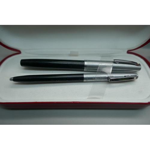 879 - A plated Sheaffer pen with 14k gold nib and two Sheaffer pen sets