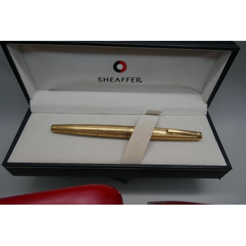 879 - A plated Sheaffer pen with 14k gold nib and two Sheaffer pen sets