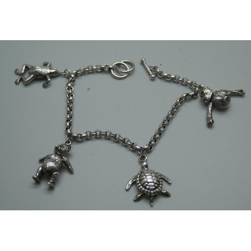 884 - A pair of 9ct white gold earrings, 1.5g, a silver charm bracelet with articulated charms including T... 