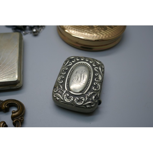 896 - A powder case, a claret decanter label, an inkwell, a lighter, three bracelets with charms, a Women'... 