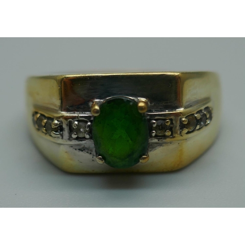 917 - A silver gilt, green and white stone ring, T