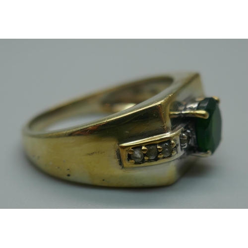 917 - A silver gilt, green and white stone ring, T