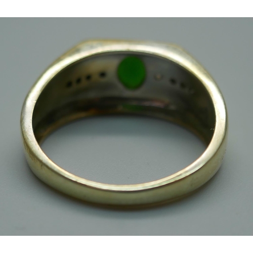 917 - A silver gilt, green and white stone ring, T