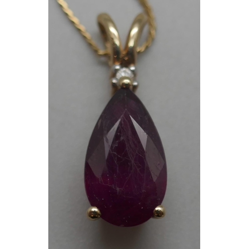 929 - A 9ct gold and ruby pendant on a 14ct gold chain, 4.4g