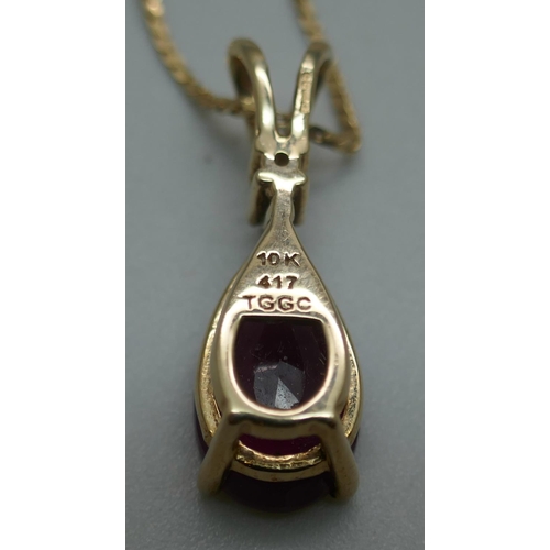 929 - A 9ct gold and ruby pendant on a 14ct gold chain, 4.4g