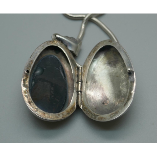 948 - A silver locket set with onyx on a silver chain