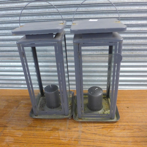 2257 - Various garden lamps, an oil lamp and 2 pot stands on wheels