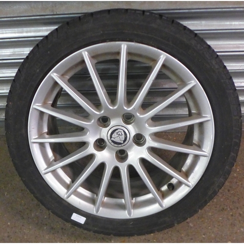 2313 - A single Jaguar alloy wheel and tyre with a Jaguar grill