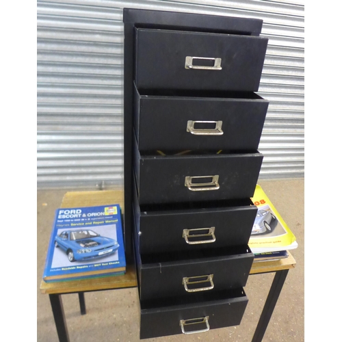 2335 - A six draw black metal under desk filling cabinet with quantity of Haynes auto manuals