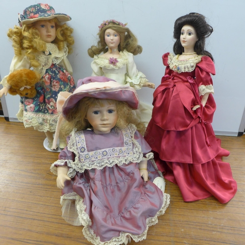 2084 - A collection of porcelain dolls on stands