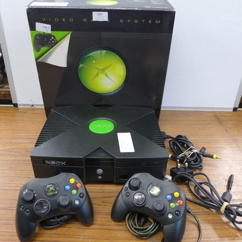 2087 - An Original Xbox games console with two original wired Xbox controller pads, power cable, A/V cables... 