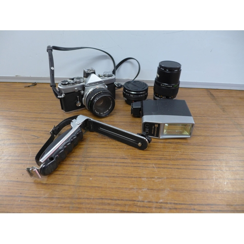 2104 - An Olympus OM-1 camera, with 2 Olympus lenses, 2 Panagor converters, flash and stand off arm