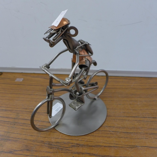 2105 - A Hinz & Kunst metal figurine, man on bicycle