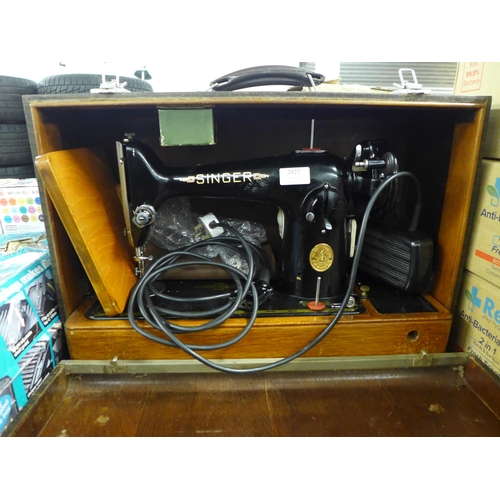 2427 - A vintage Singer electric sewing machine in case