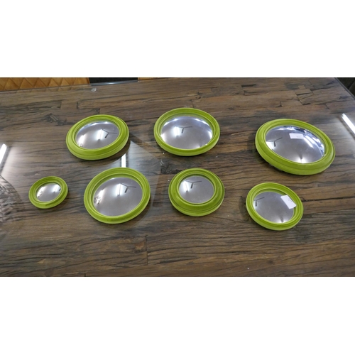 1316 - A set of seven lime green flocked convex mirrors