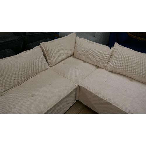 1440 - A cream upholstered modular corner sofa