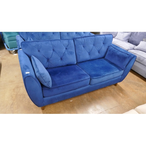 1546 - A Hoxton blue velvet three seater sofa - slight damage