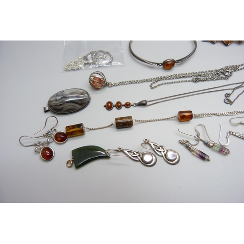 1000 - A collection of silver and silver mounted jewellery including some amber set