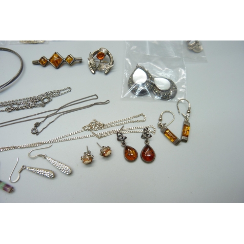 1000 - A collection of silver and silver mounted jewellery including some amber set