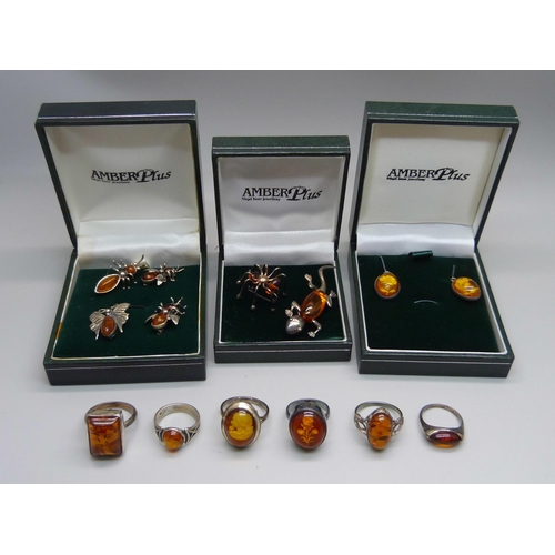 1046 - Six silver and amber rings, one with cameo of flower inlaid in the amber, a pair of amber earrings a... 