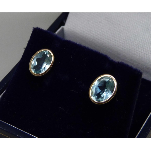 1065 - A pair of yellow metal and aquamarine earrings, tests as 9ct