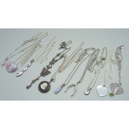 1075 - Ten silver pendants and chains