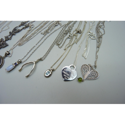 1075 - Ten silver pendants and chains