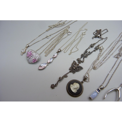 1075 - Ten silver pendants and chains