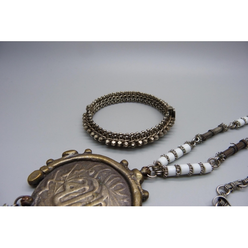 1078 - An Eastern white metal bangle and an Eastern necklace