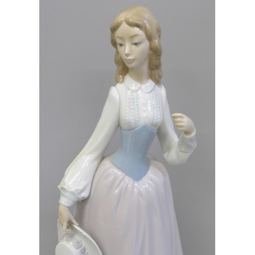 611 - A Lladro figure of a girl with hat, lacking parasol