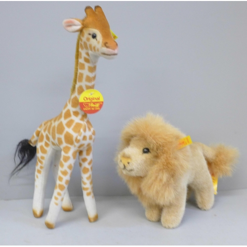 613A - A Steiff giraffe and lion, buttons and labels intact