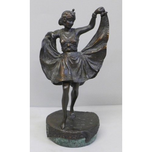 615 - A bronze Art Deco dancing girl figure on a circular base, with a hinged skirt, 13.5cm