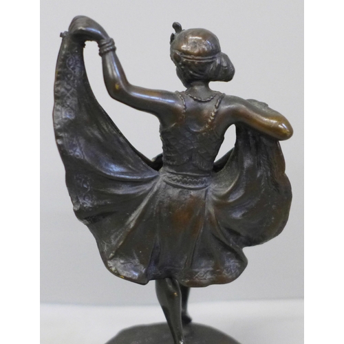 615 - A bronze Art Deco dancing girl figure on a circular base, with a hinged skirt, 13.5cm