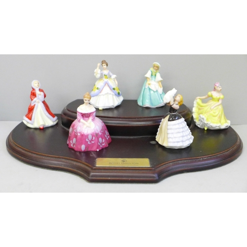 635 - Six miniature Royal Doulton ladies, boxed, with a wooden display stand