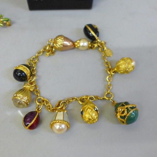 696 - Costume jewellery; a Joan Rivers boxed egg charm bracelet, seven boxed egg necklaces, a crown and eg... 