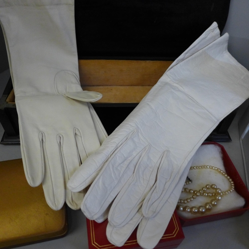 771 - A silver mounted glove box with two pairs of kid leather gloves and boxes of simulated pearls