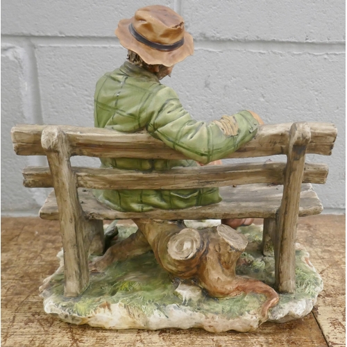 804 - A Neopolitan figure of a tramp on bench feeding a squirrel, signed Buon Cuore