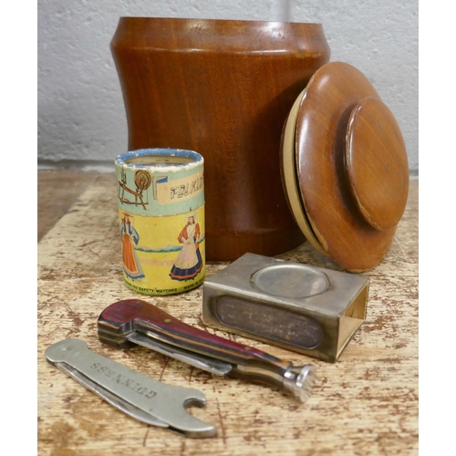 811 - An oak smokers cabinet with bevelled edge glass doors, a tobacco jar, a pipe rack and pipes