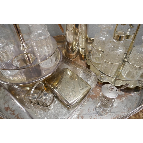 812 - Two plated gallery trays, a water jug, a plated purse, cruets and condiments