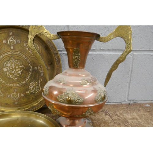 816 - An Indian brass and copper vase and two brass chargers, one with white metal lettering