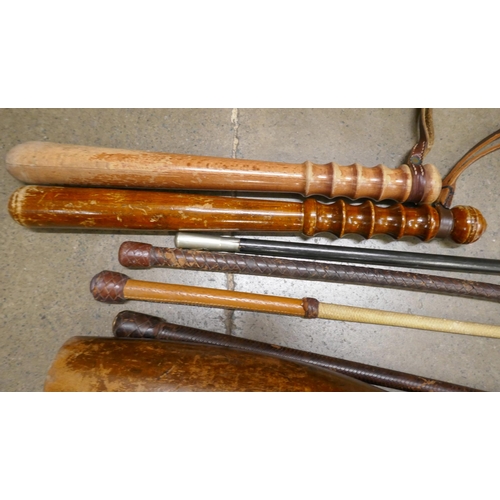 818A - Two truncheons, a pair of Indian clubs, three riding crops and a swagger stick