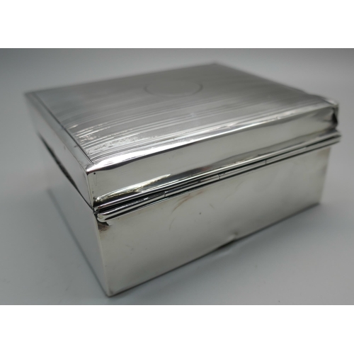 831 - A silver cigarette box with engine turned decoration to lid, gross weight 247g, a/f (lid)