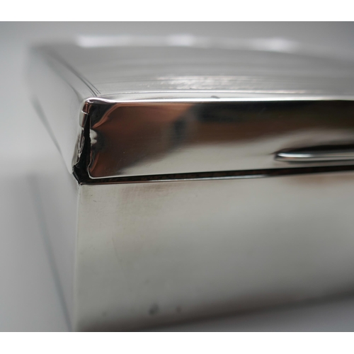 831 - A silver cigarette box with engine turned decoration to lid, gross weight 247g, a/f (lid)