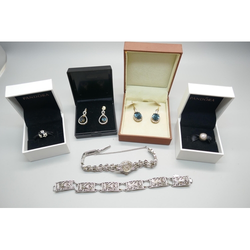 850 - Two pairs of silver gilt earrings, two Pandora charms with boxes, a bracelet and a lady's wristwatch