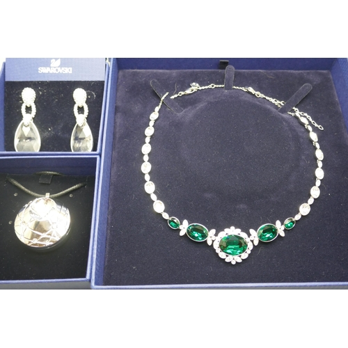 854 - Swarovski jewellery; a pair of earrings, a necklace and a face and body highlighter pendant, all box... 