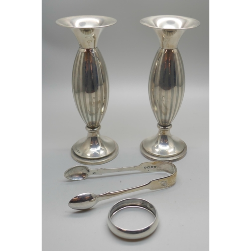 868 - A pair of silver vases, a pair of Victorian silver sugar bows and a silver napkin ring, 114g