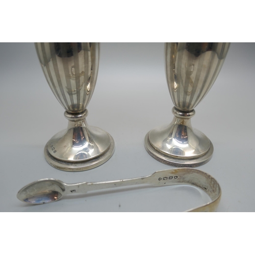 868 - A pair of silver vases, a pair of Victorian silver sugar bows and a silver napkin ring, 114g