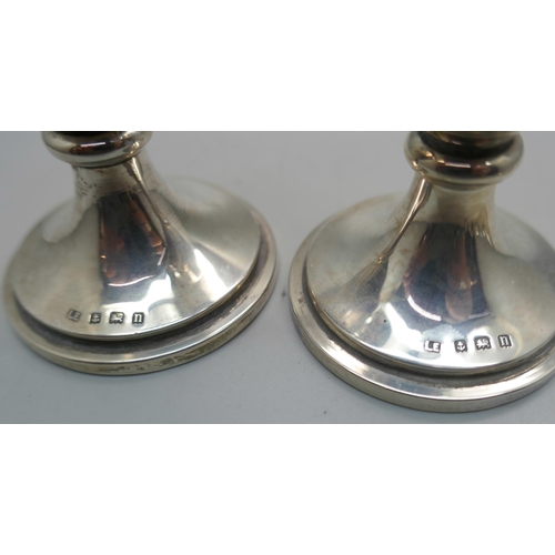 868 - A pair of silver vases, a pair of Victorian silver sugar bows and a silver napkin ring, 114g