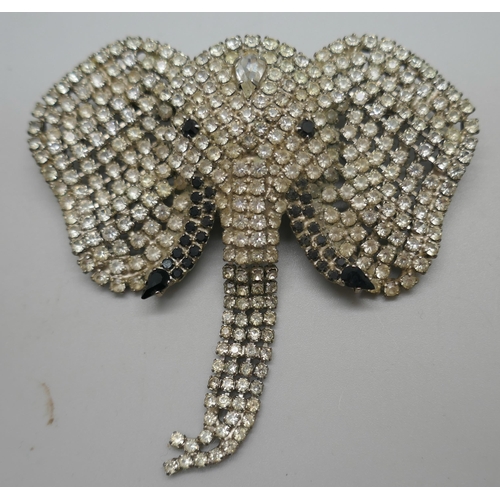 900 - A large Butler & Wilson silver plated rhinestone elephant's head brooch with articulated trunk, a vi... 